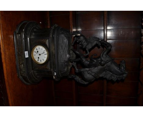 A striking slate mantel clock of waisted architectural form surmounted by a spelter Marley horse