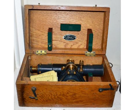 A cased theodolite with tripod and measure 