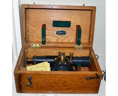 A cased theodolite with tripod and measure 