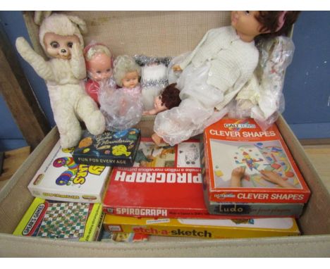 A suitcase of vintage board games and dolls