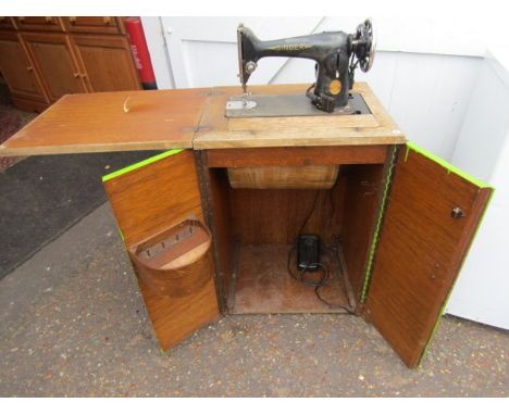 vintage singer sewing machine in cupboard