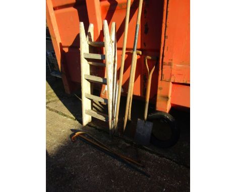 A wooden ladder for display and some garden tools