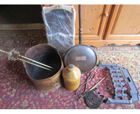 A copper coal bucket, brass fire guard, grate and companion parts plus a Peterborough stoneware bottle