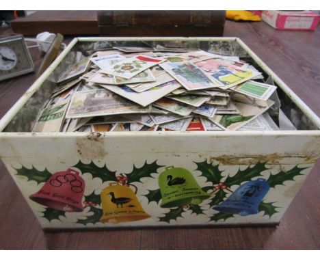 A vintage tin of cigarette cards- several 100