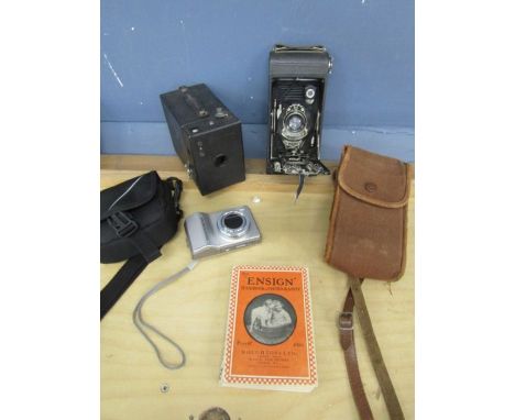 Vintage Kodak camera's, a photography book and Samsung camera
