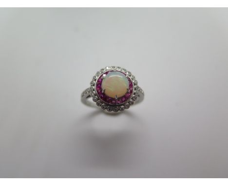 A platinum opal, ruby and diamond ring, hallmarked, size M, head approx 12mm, approx 5 grams, in good condition 