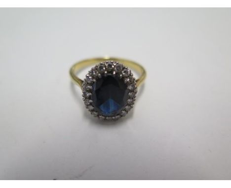 An 18ct yellow gold diamond and dark blue sapphire ring, size R, approx 4.6grams, marked 18ct. Head size 15 x 12mm with some 