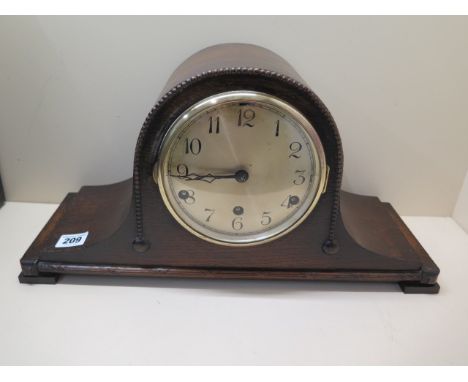 An 8 day oak case mantle clock with Westminster chimes, 45cm wide, running in saleroom 