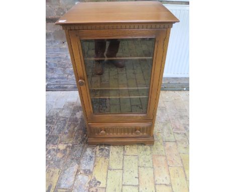 An Ercol elm glazed cabinet and base drawer, 97cm tall x 56cm x 49cm, some usage marks but generally good condition 