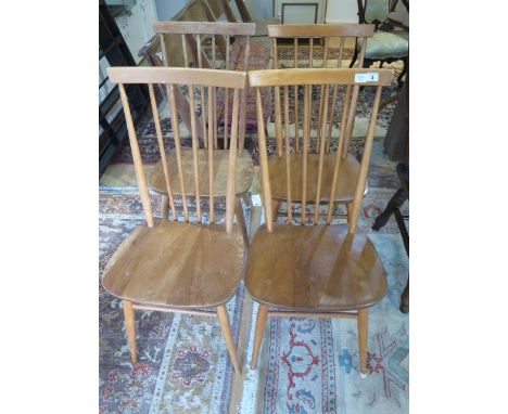 A set of four ercol 1960 elm seated kitchen chairs, numbers 2056, two have slight movement and one is stained and has woodwor