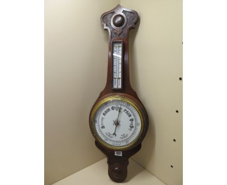 A 1930's aneroid oak case barometer, 76cm tall, polished condition, appears to be working fine 