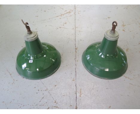 A pair of green enamel industrial ceiling lamps with white enamel interior, 48cm tall x 46cm diameter, both working when remo