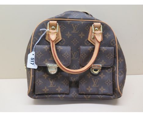 A Louis Vuitton monogrammed leather handbag with gilt metal hardware, 30cm wide, front left pocket is missing one gilt metal 