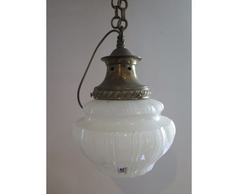 A brass and opaque glass ceiling light of moulded fluted form suspended on a linked chain, 38cm tall, several chips to rim of