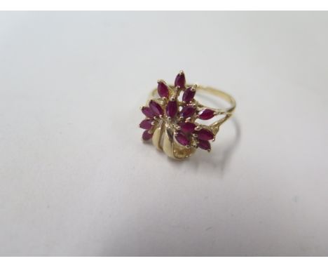 A 9ct yellow gold ruby flower spray ring, hallmarked, size R, approx 4.2 grams, in good condition 