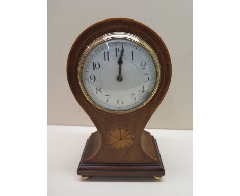An 8 day mahogany case balloon mantle clock with inlay, 23cm tall, running in saleroom 