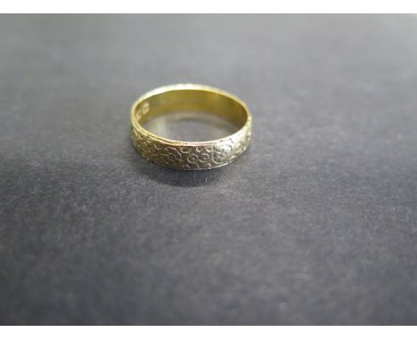 An 18ct yellow gold hallmarked band ring, size R, approx 3.8 grams 