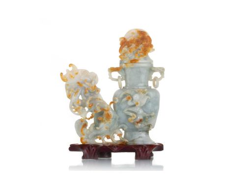 CHINESE PALE GREEN AND RUSSET JADE CARVING, 19TH CENTURY modelled as a double handled vase with ringed handles and detachable