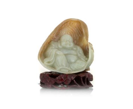 CHINESE CARVED JADE BUDDHA, 20TH CENTURY carved seated within a grotto, on fitted hardwood stand10cm high