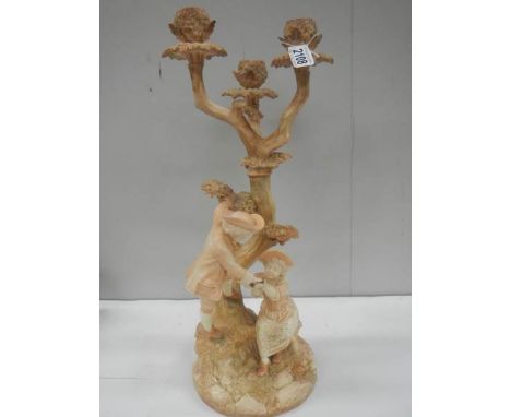 An early 20th century Royal Worcester candelabra, very slight chip on one sconce.