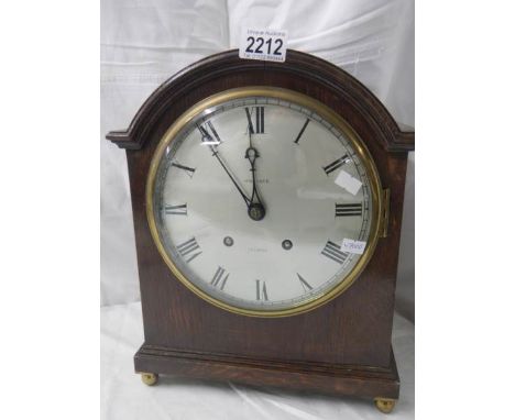 A 'Whitaker, Oldham' bracket clock with silvered dial.