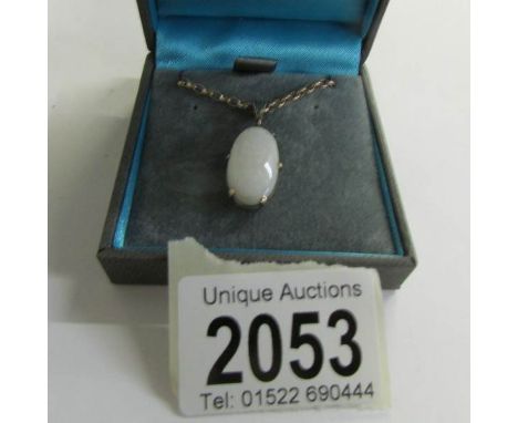 A circa 1960/70's full opal pendant in an oval shaped gold mount with attached 9ct gold chain.