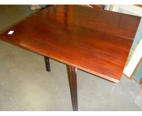 A fold over card table on square mahogany legs.