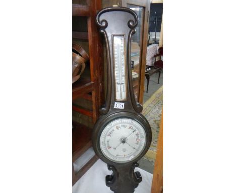 An aneroid barometer by H Manley, Opticians, Leeds.