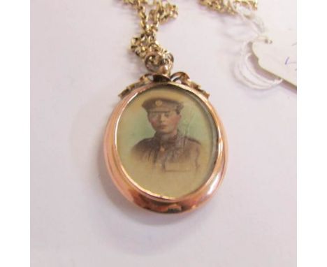 An early 20th century first world war period sweetheart locket of an young man in officer's uniform, ornate goldwork, 9ct, an