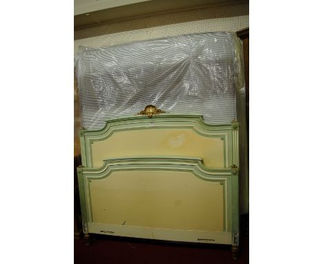 A neo-classical style painted and gilt decorated kingsize bedstead, having arched and shell capped headboard, twin side rails