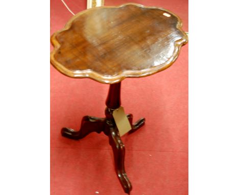 A 19th century mahogany shaped top fixed pedestal tripod occasional table