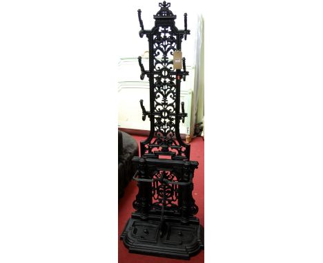 In the manner of Coalbrookdale - a black painted and cast iron hall stand, having twin lower integral stick stand holders, 6 