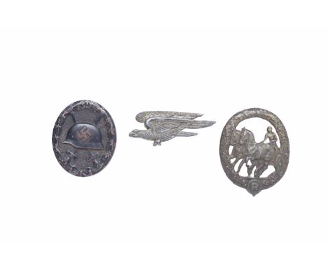 COLLECTION OF GERMAN MILITARY BADGESincluding WWII Third Reich Black Wound badge, a German equestrian-related badge, inscribe