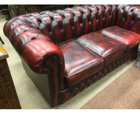 GROUP OF BUTTONED OXBLOOD LEATHER DRAWING ROOM FURNITUREcomprising three seat Chesterfield-style sofa, approximately 190cm wi