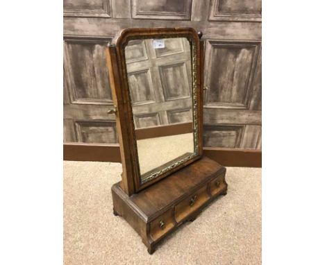 GEORGE III WALNUT DRESSING GLASSupright plate within a moulded frame on a box base, fitted three drawers, on ogee bracket fee