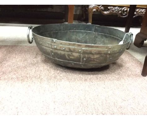 ARTS & CRAFTS STYLE OVAL PLANTER with two ring handles and of studded sections, 49cm wide; together with a large copper plant