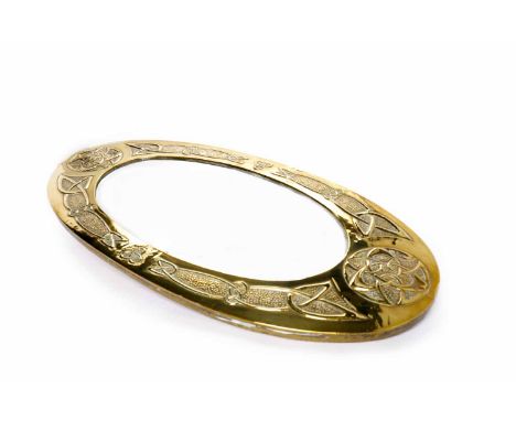 ARTS & CRAFTS GLASGOW SCHOOL OVAL BEVELLED WALL MIRROR contained in a wide hammered and embossed brass frame, decorated with 