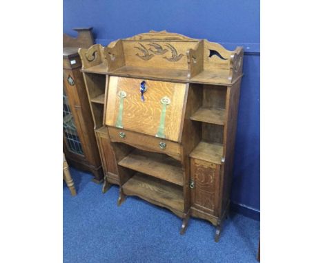ARTS & CRAFTS OAK ESCRITOIRE BOOKCASE OF LIBERTY DESIGN the raised back carved with three flying swallows, fall front writing