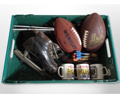 A box of pair of vintage leather ice skates, American footballs, darts etc 