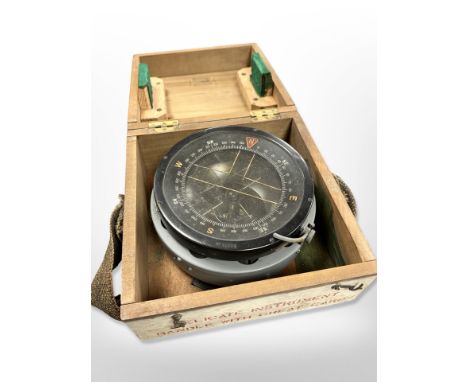 A large military compass in wooden box 