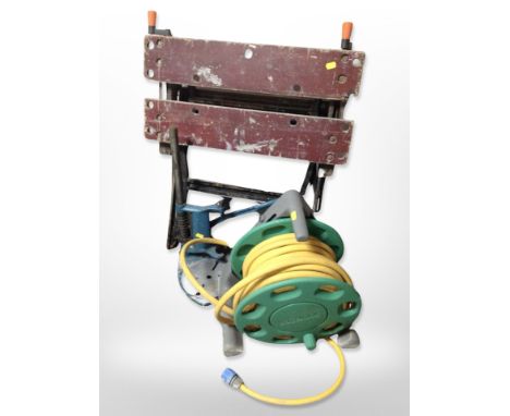 A folding work bench, garden hose pipe etc 