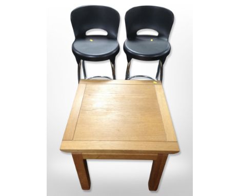 A contemporary square oak lamp table, width 60 cm, together with two chrome and plastic stools 
