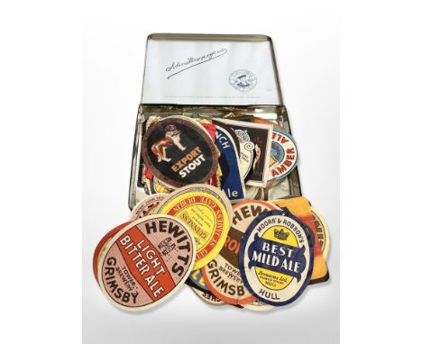 A vintage Player's Navy Cut cigarette tin together with a collection of vintage beer labels