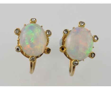 A pair of oval opal earrings, oval stones in claw settings on yellow metal screw backs stamped 9ct, 3g.