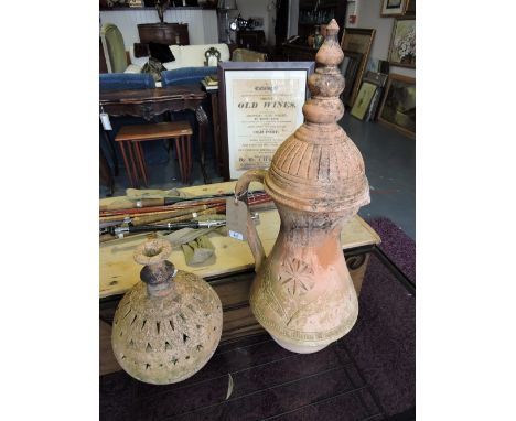 A 20th century terracotta garden ornament of baluster form, together with terracotta reticulated globe. (2)