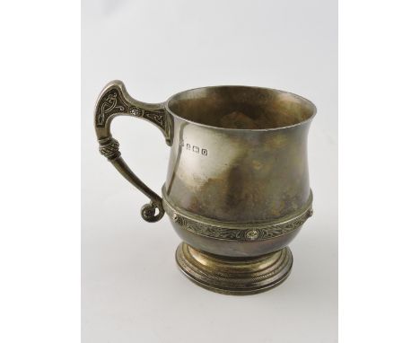 A silver christening mug, Adie Bros. Birmingham 1939, of squat baluster form with a lindisfarne pattern girdle, 7ozt.