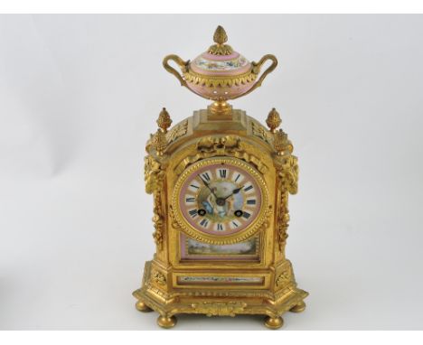 A late 19th century gilt metal and sevres style mounted mantel clock, panels emblematic of the arts and bucolic scenes, mount