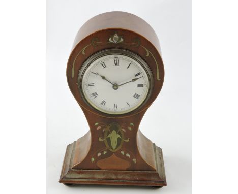 An Edwardian mahogany mantel clock, the case inset with pewter and mother-of-pearl, the white dial set out with Roman numeral