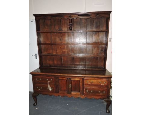 An 18th century style oak and mahogany banded dresser, the raised back with a pierced shaped frieze and arrangement of three 