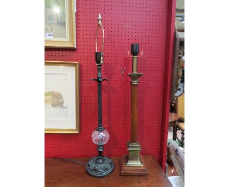 A wood and brassed effect column form table lamp with plinth base and a black metal table lamp with glass ball detail (2) 